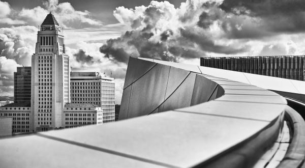 Black and white architectural photography of "City Hall" by Schiffer Publishing, Ltd. captures a skyscraper, dramatic clouds, and modern curves, emphasizing American civic architecture in its striking design.