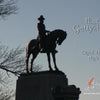 A statue of a man on horseback stands on a pedestal beneath a clear sky, bare trees to the left. The text "Haunted Gettysburg" invites you to explore Gettysburg ghosts. Product: Haunted Gettysburg by Schiffer Publishing, Ltd.