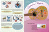 An open craft book, Wax on Crafts by Schiffer Publishing, Ltd., shows crayon wax jewelry (pendants, brooches) on the left and a decorated guitar under "Advanced Projects: Secret Garden Guitar" on the right.