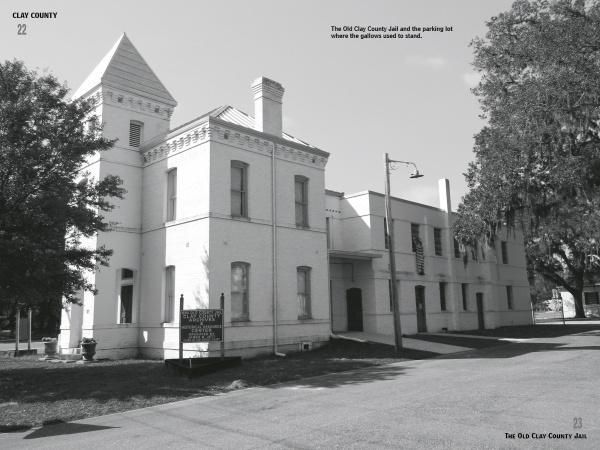 Black and white photo of the Old Clay County Jail—a two-story, white brick building with a tower and arched windows—featured in Schiffer Publishing, Ltd.'s "Women in White," known for its connections to northeast Florida ghost stories.