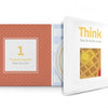 An open Think Squares! book by Schiffer Publishing, Ltd. shows the page “1 Yummy Square What can it be?” and a flap reading “Think Then lift the flap to see!” encouraging analytical thinking, with a partially visible waffle.