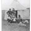 A black-and-white image from Schiffer Publishing, Ltd.'s "Fort Abraham Lincoln" shows four Indigenous men in traditional clothing by a canvas tipi on grassy land, with a dog lying in front.