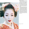 A Kyoto geisha in traditional attire and elaborate hair ornaments looks calmly at the camera. She wears white face makeup, red lips, and a red kimono. Text and an interview appear on the right. From "Geisha & Maiko of Kyoto" by Schiffer Publishing, Ltd.