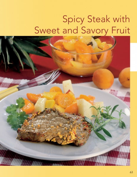 A plate with cooked steak and herbs beside colorful fruit, with a bowl of assorted fruit and pineapple in the background, inspired by "Cooking with Mustard" from Schiffer Publishing, Ltd.