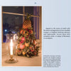 The book "Delicious Christmas Decorations at Historic Houses and Your Home" by Schiffer Publishing, Ltd. shows Colonial Williamsburg-style displays of pineapples, oranges, apples, and greenery in festive windowsills beside candlelight at dusk.