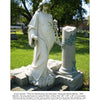 A white marble statue stands by an old gravestone amid grass and trees, evoking the atmosphere found in Amish Folk Tales & Other Stories of the Pennsylvania Dutch from Schiffer Publishing, Ltd.