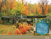 Amid autumn trees, the Dublin Town Pound—featured in "New Hampshire" by Schiffer Publishing, Ltd.—offers a striking photo spot. An inset reveals a green sign about its 18th-century role holding stray animals.