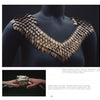 A close-up shows a sculptural necklace with copper and iron scales in a V shape; an inset depicts hands holding similar wearable art. Featured in "Art Jewelry Today 3" by Schiffer Publishing, Ltd.