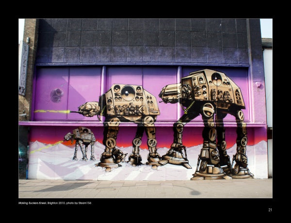 Exterior street art mural of three large AT-AT walkers as boomboxes in front of a purple-pink backdrop, inspired by UK graffiti writers and featured in "100 UK Graffiti Artists" from Schiffer Publishing, Ltd.