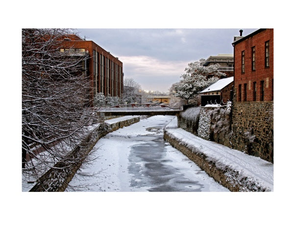 The Chesapeake and Ohio Canal by Schiffer Publishing, Ltd. captures the canal’s history with frozen waters, snowy paths, red brick buildings, bare trees, and a cloudy winter sky.
