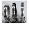 Three silver Fred Harvey Jewelry bracelets with zigzag lightning and sunburst designs, exemplifying Southwestern Indian artistry, are featured upright against a plain background. Brand: Schiffer Publishing, Ltd.