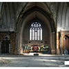 The interior of an abandoned church with high arched ceilings and broken walls features "Detroit Graffiti" art—colorful lettering and a skull—on the back wall beneath a large stained-glass window. Brand: Schiffer Publishing, Ltd.