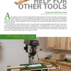 A magazine page from "Home Workshop Jigs and Fixtures" by Schiffer Publishing, Ltd. showcases a wooden drill-press table in a cabinet-lined workshop, detailing how to build this essential fixture with listed dimensions.