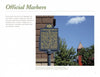 The book "Signs of Lancaster County" by Schiffer Publishing, Ltd. explores historical markers like one set near bushes before a red brick building, detailing Lancaster County's founding and its place in Amish Country.