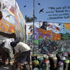A person with a covered head spray-paints a mural on a wall, surrounded by spray cans, in true Santiago street art style. "Street Art Santiago Chile" by Schiffer Publishing, Ltd. captures vibrant graffiti and bold quotes about graffiti culture.