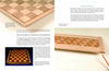 A page from "Laminated Wood Art Made Easy" by Schiffer Publishing, Ltd. displays three photos of wooden chessboards at different construction stages, with text on woodworking basics, symmetrical wood patterns, and wood moisture effects.