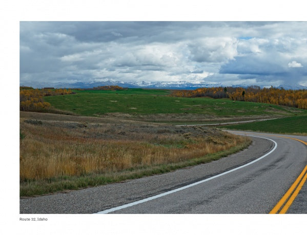 Yellowstone Country by Schiffer Publishing, Ltd. showcases panoramic views of winding rural roads, grassy fields, autumn trees, and distant snow-capped peaks—capturing the stunning scenery of Yellowstone National Park.