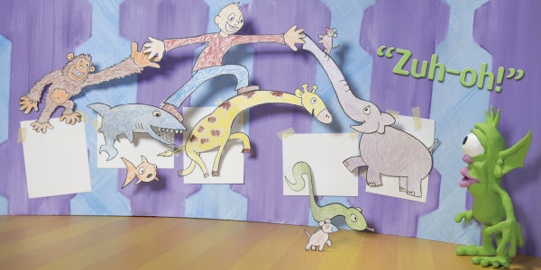 A green modeling-clay character reacts in surprise to five playful cutouts on a blue-purple wall under the text “Zuh-oh!”—capturing the whimsy of Gruel Snarl Draws a Wild Zugthing from Schiffer Publishing, Ltd.