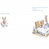 In "The Wolf Will Not Come" by Schiffer Publishing, Ltd., a small rabbit lies in bed under a blanket as an adult rabbit sits nearby, comforting the child and reassuring them through nighttime fears in this heartwarming picture book scene.