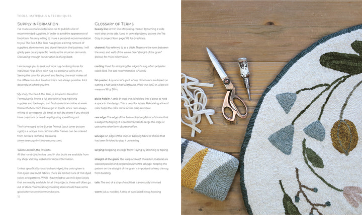 An open book, "Rug Hooking with Wool Strips" by Schiffer Publishing, Ltd., displays supplies and tips. Nearby: a floral rug, thread, scissors, hook tool, and towel—ideal inspiration for modern crafters or punch needle enthusiasts.