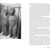 A black-and-white photo shows two ancient stone statues, joined at the shoulders, displayed in a glass case. The image, featured in Carolina Haints by Schiffer Publishing, Ltd., is bordered by text on both pages.