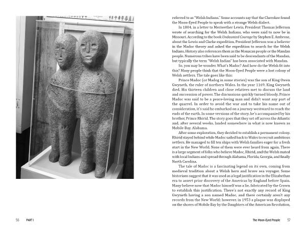 A black-and-white photo shows two ancient stone statues, joined at the shoulders, displayed in a glass case. The image, featured in Carolina Haints by Schiffer Publishing, Ltd., is bordered by text on both pages.