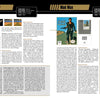 Two magazine pages from Schiffer Publishing’s The NES Omnibus showcase reviews of Mach Rider and Mad Max, with game covers, screenshots, detailed text, stats, insights for retro fans, and black/yellow headline banners at the top.
