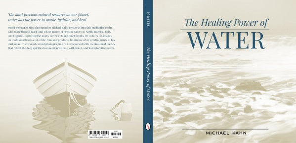 Book cover for Healing Power of Water by Schiffer Publishing, Ltd. features tranquil water photography with a calm boat and serene reflections. The title appears in large blue letters above the author’s name in a white and beige palette.