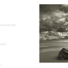 A sepia-toned photo from Healing Power of Water by Schiffer Publishing, Ltd. shows a large rock on a sandy beach under dramatic clouds. A quote on the left reads, “How wild it was to let it be.” —Cheryl Strayed. Ideal for classic print lovers.