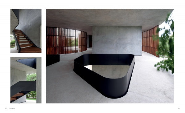 Showcasing the sculptural architecture of stairs and interiors, Concrete Houses by Schiffer Publishing, Ltd. features minimalist spaces with smooth concrete walls and floors, black metal railings, and vertical wood slats letting in natural light.