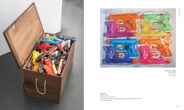 A wooden box sits on a gray floor, filled with colorful plastic toy guns. Next to it is an image of six water guns in clear packaging. "Loaded" by Schiffer Publishing, Ltd. offers a striking nod to gun culture in contemporary art.