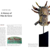 A two-page spread from "Pâte de Verre" by Schiffer Publishing, Ltd. features history text on the left and, on the right, a photo of a translucent glass sculpture—an animal head with horns—mounted on a black base, highlighting glass artistry.