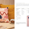 A pink abstract cushion with textured shapes in white, red, and peach sits on a beige chair—a perfect Punch Needle project for beginners. Instructions and materials by Schiffer Publishing, Ltd. are shown on the right with a close-up of the design.