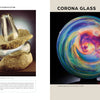 On the left is a smooth stone and glass sculpture on sand. On the right, a vibrant, swirling glass sphere by Josh Simpson from Schiffer Publishing, Ltd. Text above reads: CORONA GLASS.