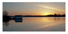 A tranquil lake at sunset near a boathouse captures Maryland's Eastern Shore, featured in "Maryland's Eastern Shore" by Schiffer Publishing, Ltd., highlighting the beauty of Blackwater National Wildlife Refuge.