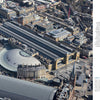 Aerial view of London’s King’s Cross and St Pancras, featured in "Train Stations of the World" by Schiffer Publishing, Ltd. The stations’ historic architecture and surrounding cityscape are shown, with text about Europe and England on the right.
