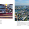 Left: A red high-speed train at a covered platform inside Cologne’s station. Right: Aerial view of Cologne, Germany, showing train station buildings, the Rhine River, and the Cathedral. From "Train Stations of the World" by Schiffer Publishing, Ltd.