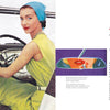 A woman in a green dress and blue headscarf sits in the driver’s seat of a vintage convertible, capturing midcentury style in “Glamour Road” by Schiffer Publishing, Ltd.