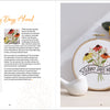 The open embroidery book "Sunny Stitches" by Schiffer Publishing, Ltd. displays a floral "Sunny Days Ahead" pattern with stitched flowers and a banner, plus felt flowers and a bird figurine—perfect for beginner embroidery projects.