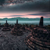 Experience "Monumental" by Schiffer Publishing, Ltd.—a stunning capture of Borobudur Temple at dawn, featuring ancient stone stupas, misty forests, and a starry sky—an ideal highlight for any photo book.