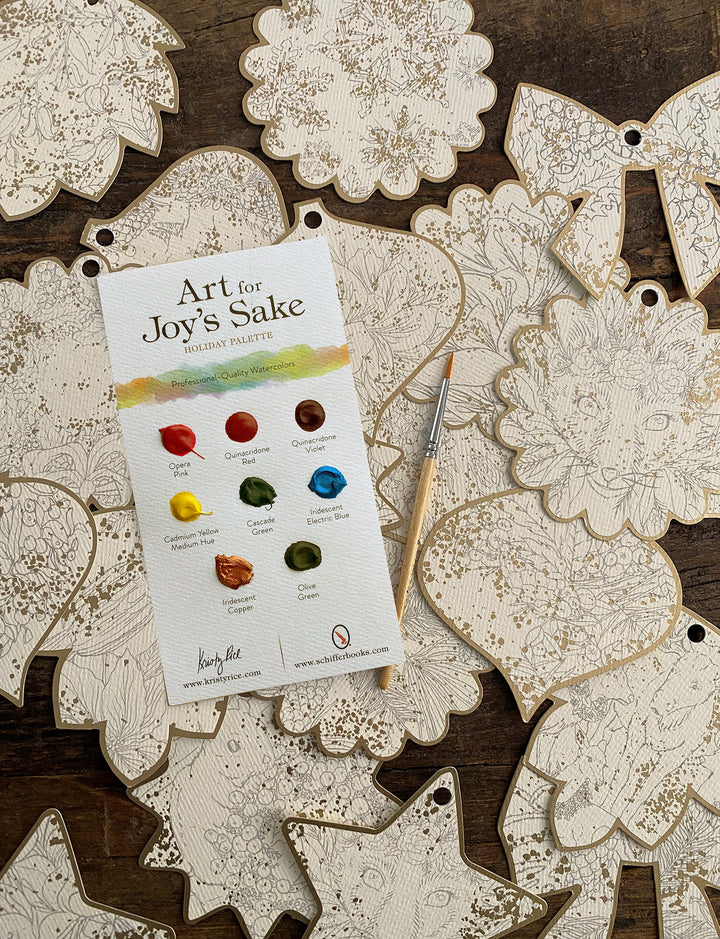 The Paint-Your-Own Holiday Decorations kit by Schiffer Publishing, Ltd. includes unpainted wooden ornaments, a paintbrush, and an instruction card, perfect for creating festive watercolor holiday décor.