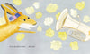 A cheerful rabbit in a colorful hat excitedly eyes a shiny tuba amid yellow roses on gray, blending music and nature. Text below says, So he decided to learn...the tuba! Product: The Tree in My Tuba by Schiffer Publishing, Ltd.