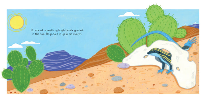 A blue-striped lizard crawls from beneath a white desert rock, cacti nearby, bathed in sun under a blue sky and purple mountains. “Up ahead, something bright white glinted in the sun. Bo picked it up in his mouth.” A Bone for Bo, Schiffer Publishing, Ltd.