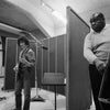 A black-and-white photo evokes a Chess Studios Chicago, 1969 vibe with two musicians—one smiling on electric guitar, the other serious on upright bass—like the "Fleetwood Mac in Chicago" album from Schiffer Publishing, Ltd.