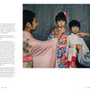 Two children in traditional Japanese clothing stand side by side as adults adjust their outfits—a fitting scene for "Japan" by Schiffer Publishing, Ltd., a photography book celebrating the beauty of Japanese culture.