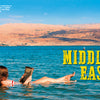 A person reads a book while floating in the Dead Sea, surrounded by blue water and desert hills. Text: “MIDDLE EAST.” Explore world traditions or test travel trivia with "Useless Knowledge for the World Traveler" by Schiffer Publishing, Ltd.