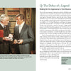 Two men in suits talk in an office. The older, exuding 007-style composure, gestures with a folder, while the younger listens, holding a briefcase. On the table is Schiffer Publishing’s "101 Things You Should Know about James Bond 007.