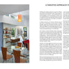 A modern, open-plan dining area in The Forever Home by Schiffer Publishing, Ltd. features a wooden table, four orange chairs, and built-in shelving. Large windows and glass doors fill the adaptable space with natural light.