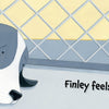 A sad black and white dog named Finley lies behind a kennel fence as a boy peeks through a green door. "Finley Feels" by Schiffer Publishing, Ltd. helps kids gently explore emotions, with the text reading, “Finley feels sad.”.