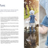 A baby, seen from behind in knitwear from "Summer Knitting for Little Sweethearts" by Schiffer Publishing, Ltd., stands in a puddle with blue and grey Scandinavian-style pieces, reflected in the water amid blurred trees and grass.